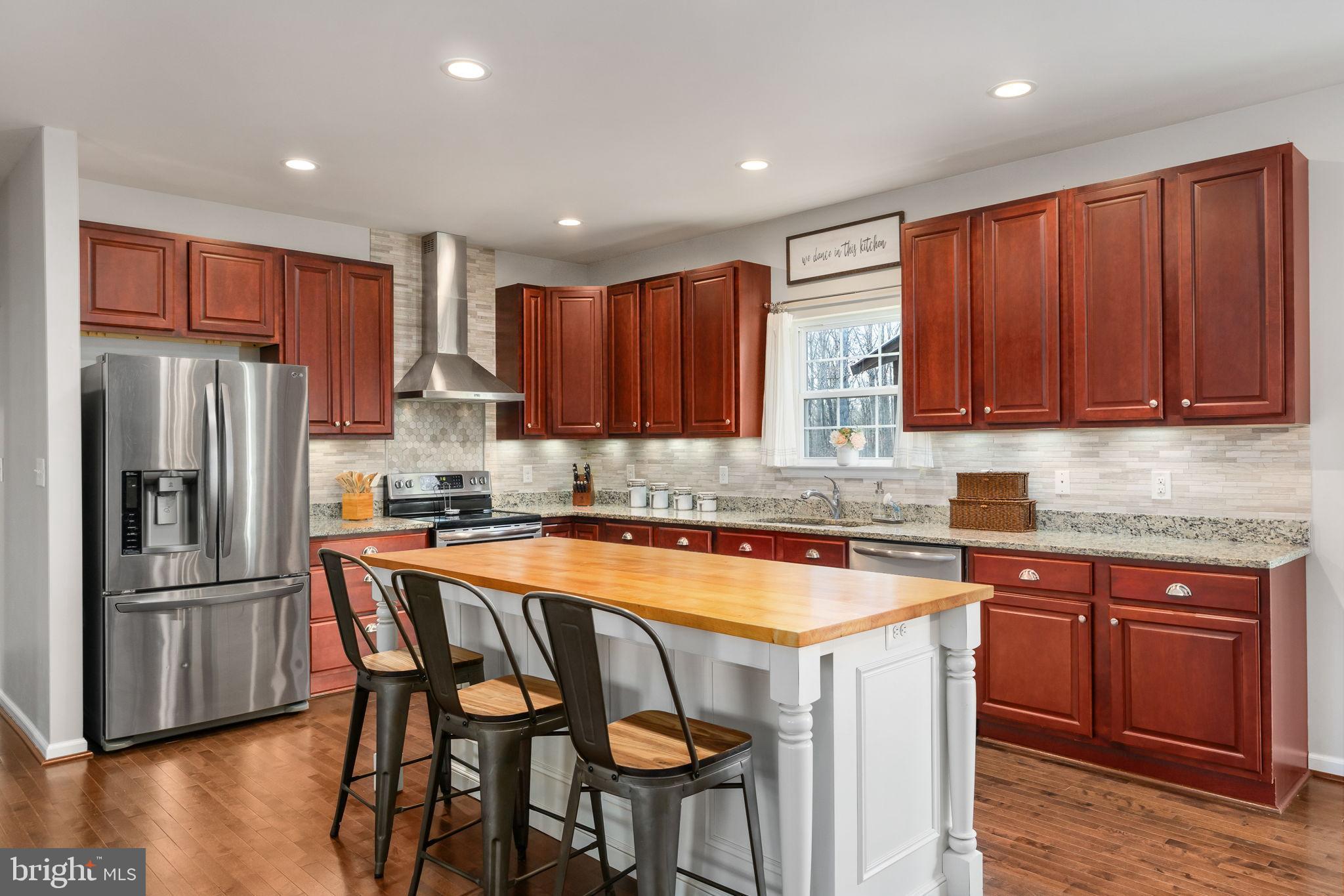 13026 Elk Run Road Bealeton, VA 22712 - Photo 19 of 55 Modern kitchen with rich wood accents.