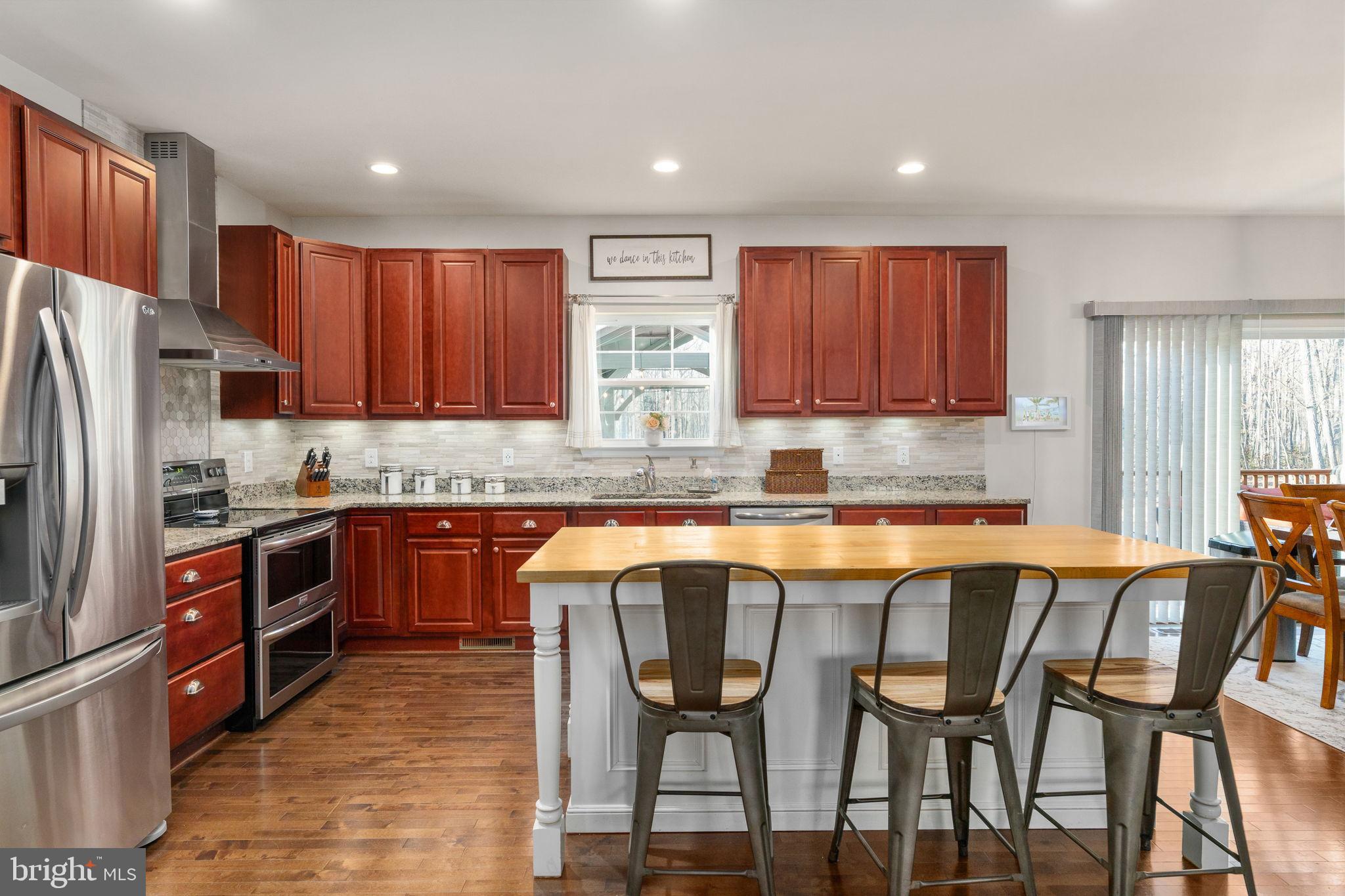 13026 Elk Run Road Bealeton, VA 22712 - Photo 21 of 55 Modern kitchen with rich wood accents.