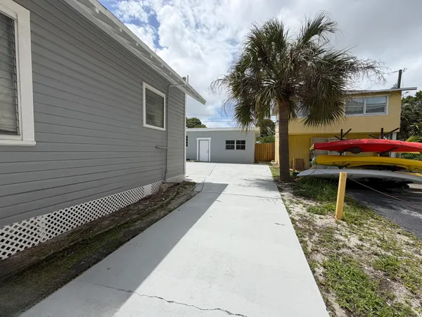a street sign on a sidewalk next to a road