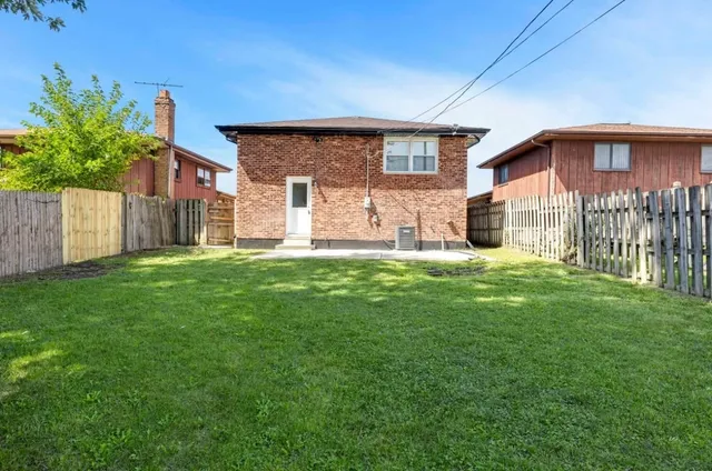 an aerial view of multiple houses with yard
