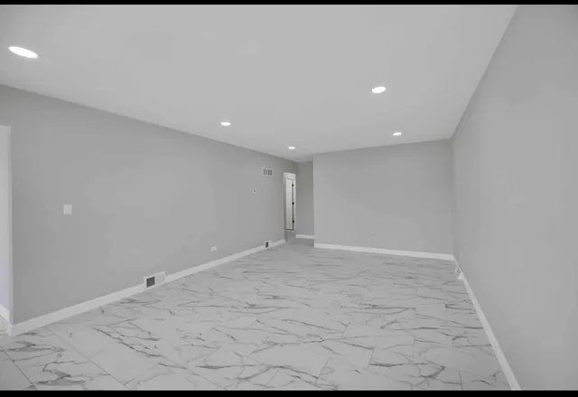 a living room with furniture a rug and a flat screen tv
