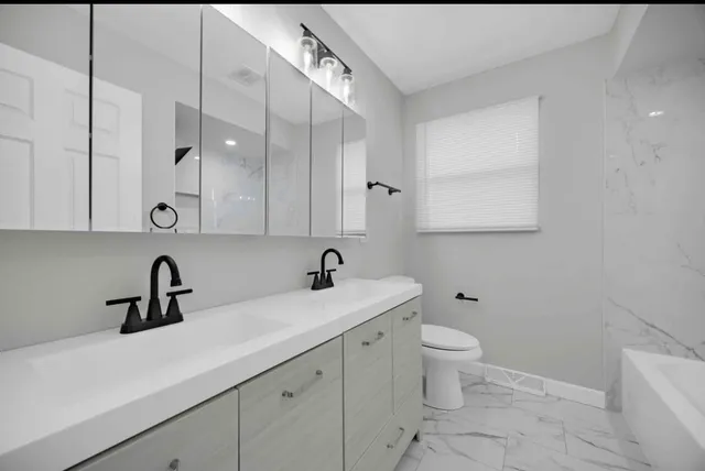 a kitchen with a sink stainless steel appliances and cabinets