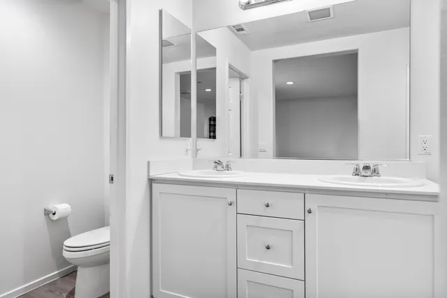 a bathroom with a toilet sink and mirror