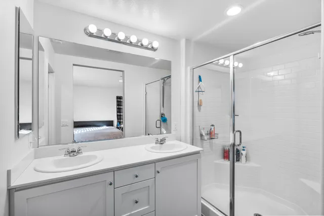 a bathroom with a double vanity sink mirror and double