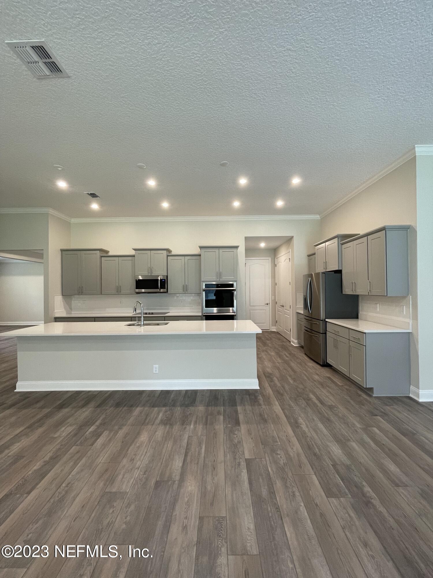 1521 Lake Foxmeadow Road Middleburg, FL 32068 - Photo 11 of 25 a view of kitchen with stainless steel appliances kitchen island granite countertop a large counter top and oven