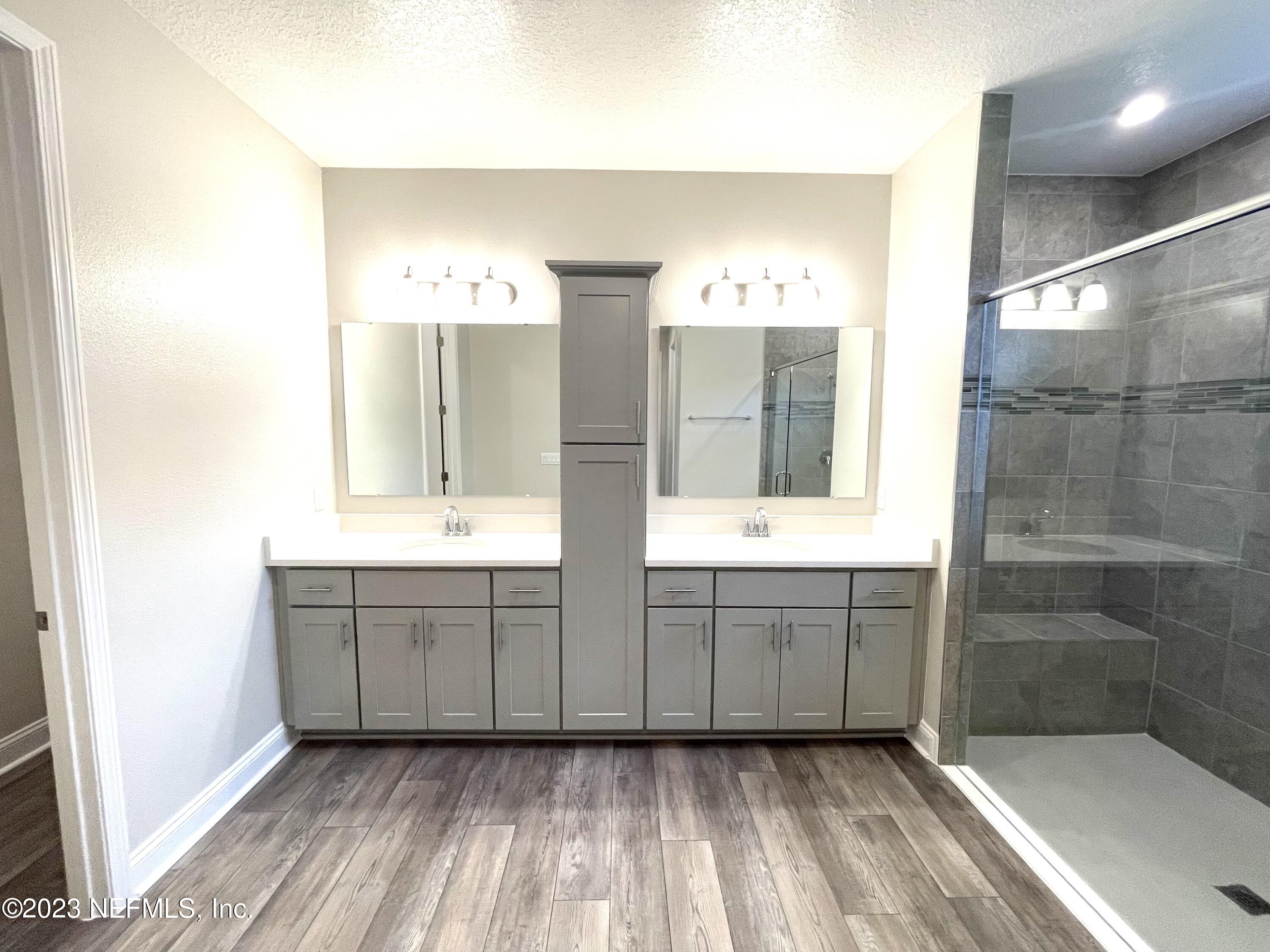 1521 Lake Foxmeadow Road Middleburg, FL 32068 - Photo 17 of 25 a bathroom with a double vanity sink mirror and shower