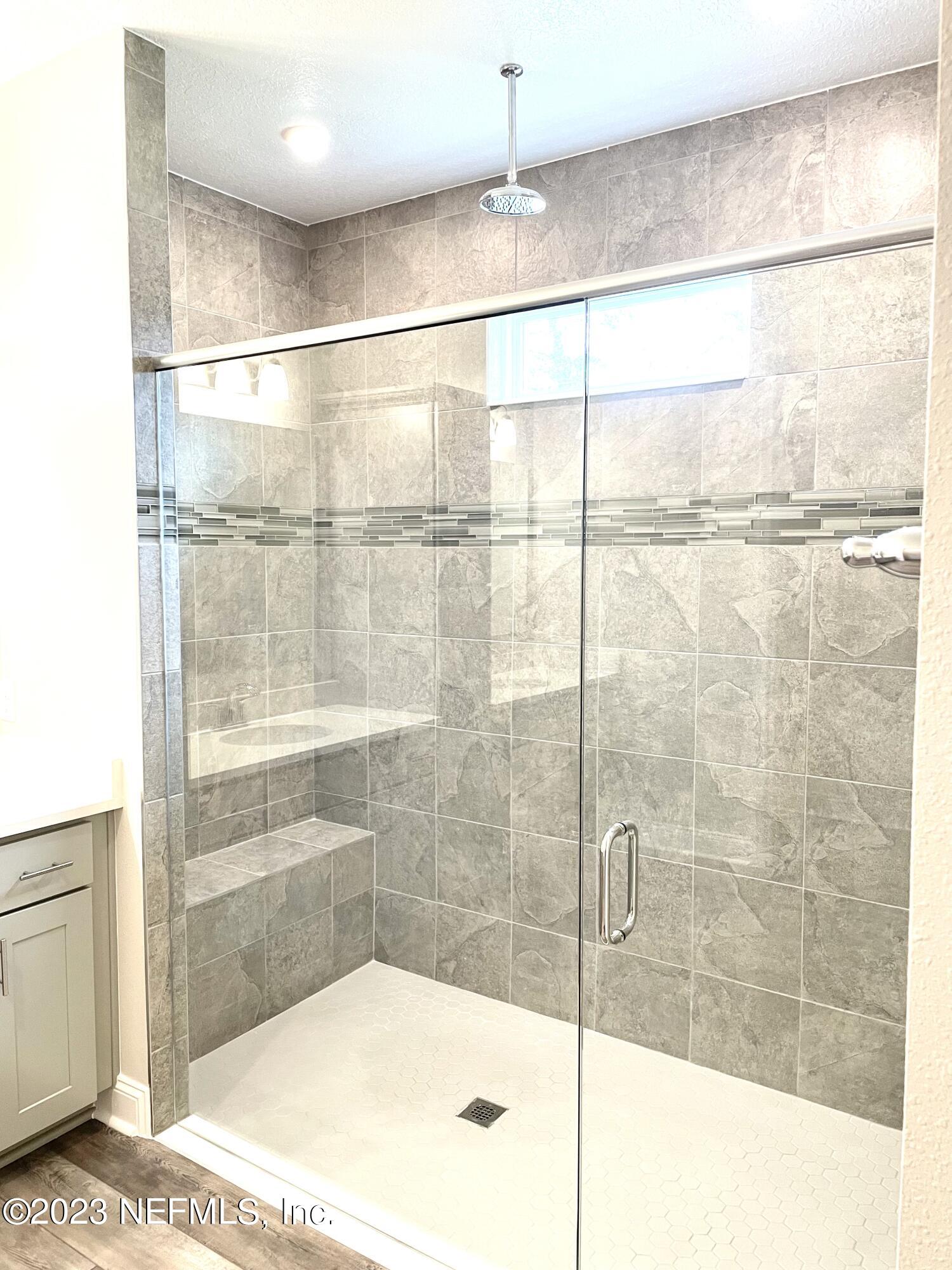 1521 Lake Foxmeadow Road Middleburg, FL 32068 - Photo 19 of 25 a bathroom with a bathtub and a shower