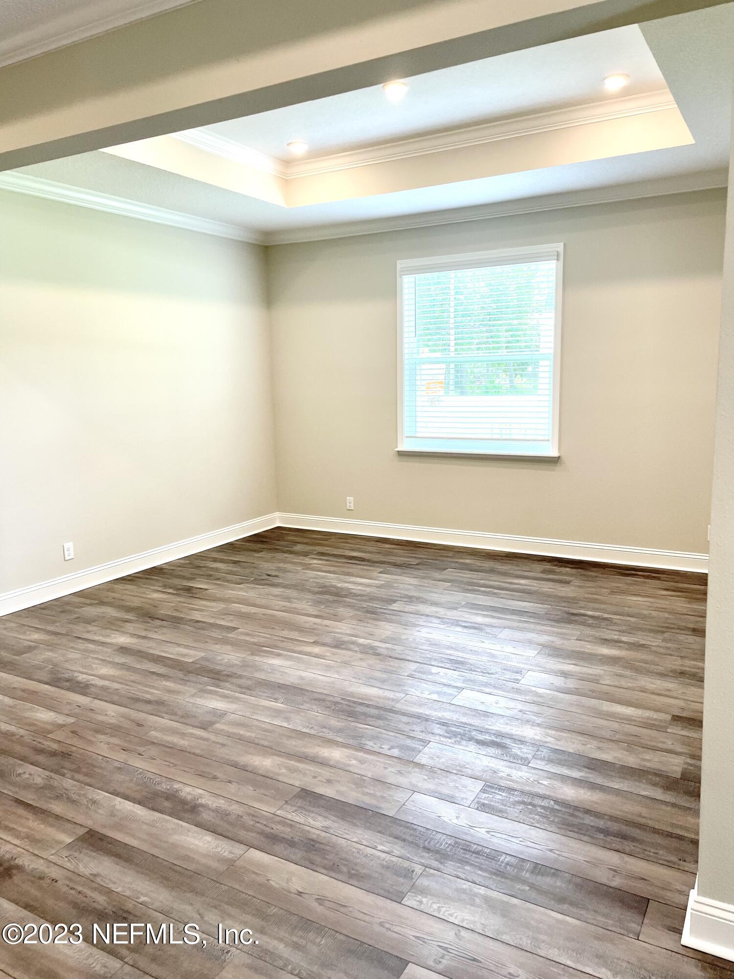 1521 Lake Foxmeadow Road Middleburg, FL 32068 - Photo 20 of 25 a view of an empty room with wooden floor and a window