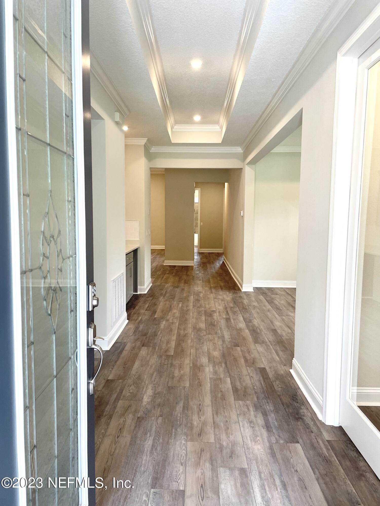 1521 Lake Foxmeadow Road Middleburg, FL 32068 - Photo 2 of 25 a view of a hallway with wooden floor and a living room