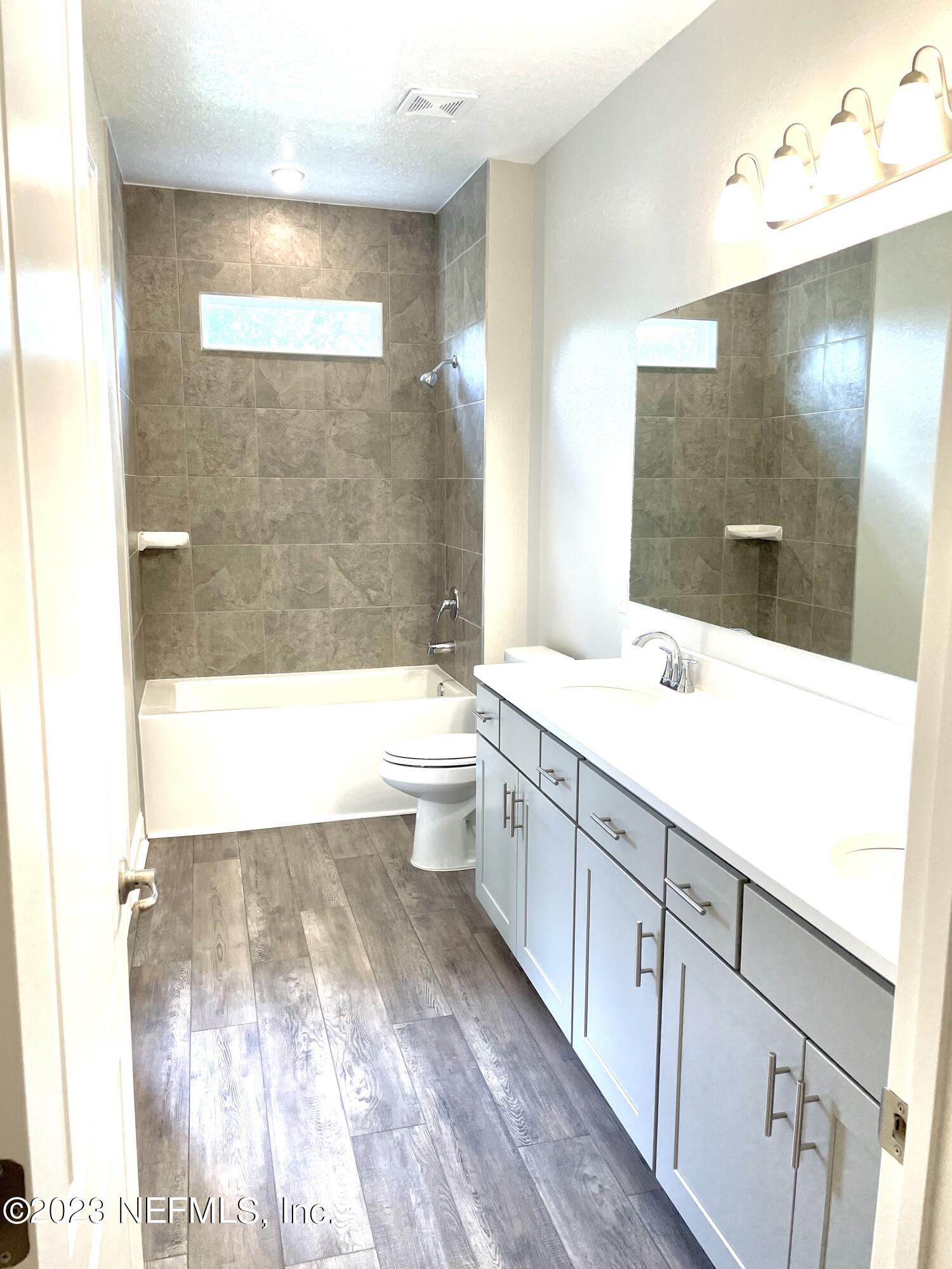1521 Lake Foxmeadow Road Middleburg, FL 32068 - Photo 24 of 25 a bathroom with a bathtub shower sink and mirror