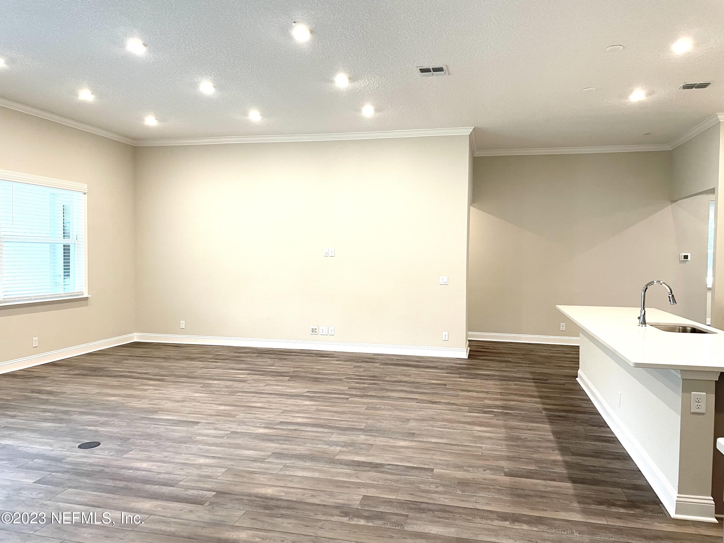 1521 Lake Foxmeadow Road Middleburg, FL 32068 - Photo 5 of 25 a view of an empty room with wooden floor and a window