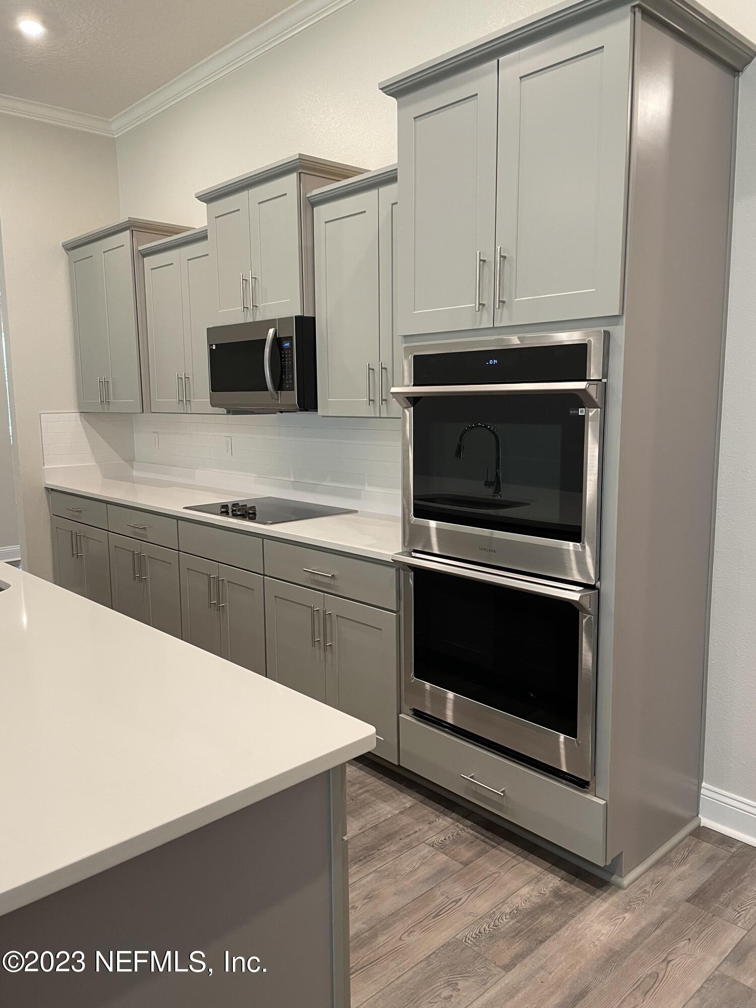 1521 Lake Foxmeadow Road Middleburg, FL 32068 - Photo 7 of 25 a kitchen with granite countertop a stove top oven and cabinets