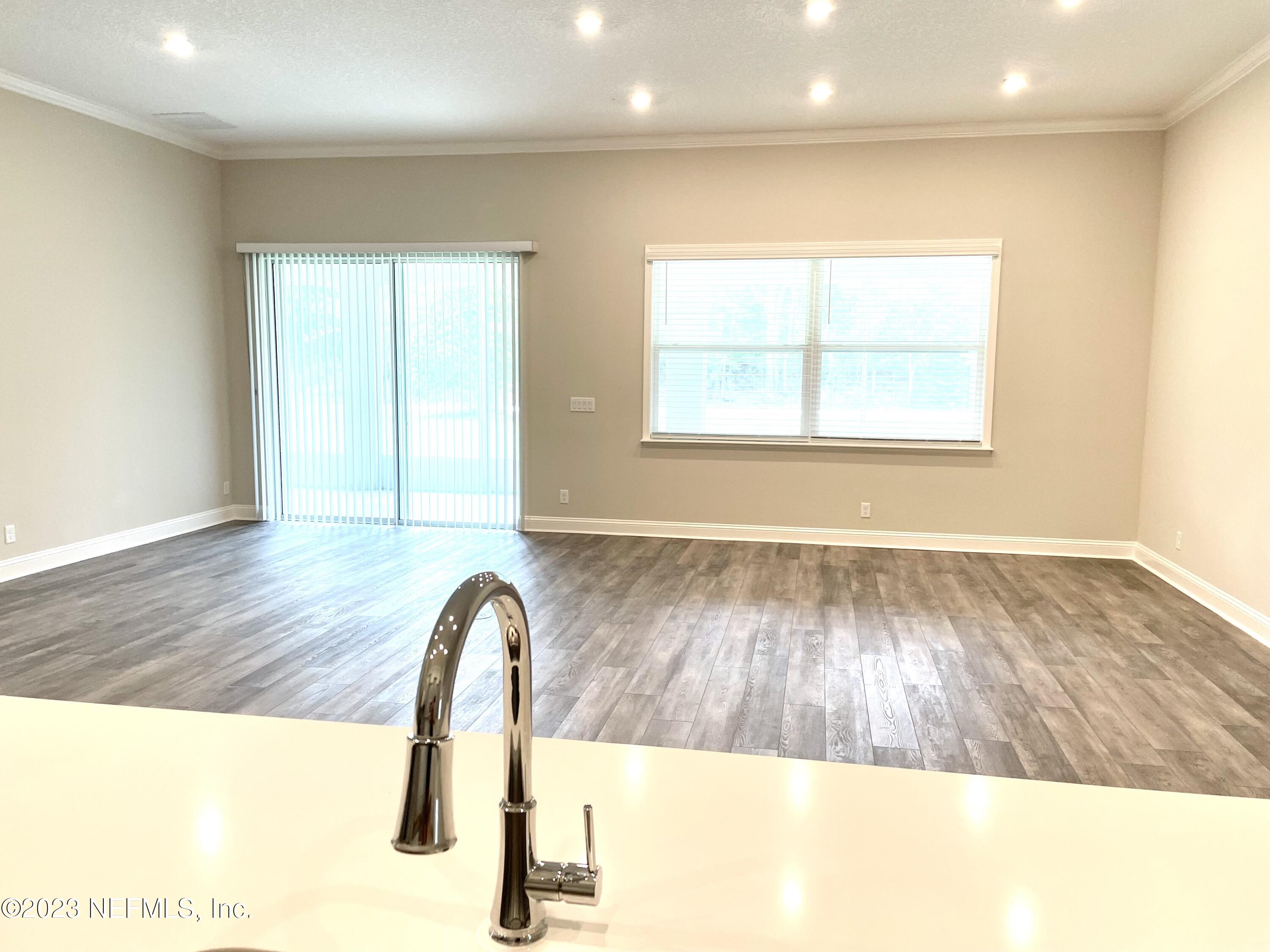 1521 Lake Foxmeadow Road Middleburg, FL 32068 - Photo 8 of 25 a picture of a room with a window and wooden floor