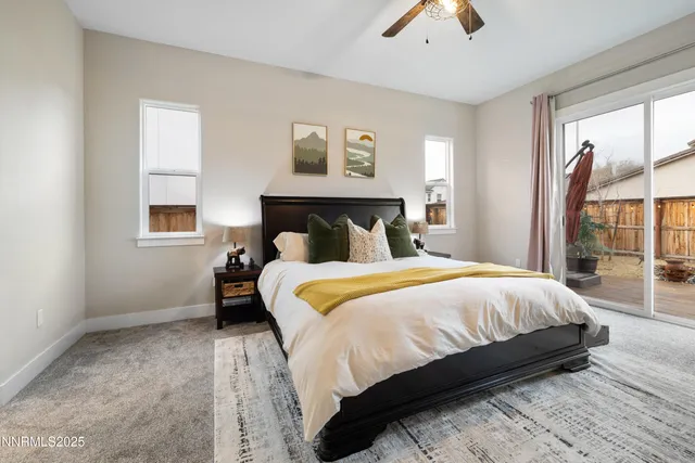 a bedroom with a bed and a large window