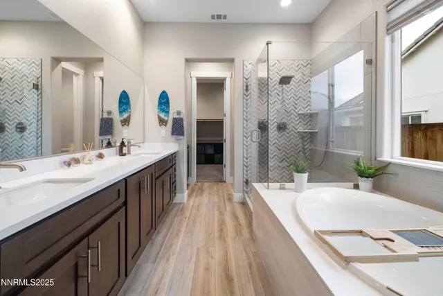 a bathroom with a granite countertop sink and a large mirror