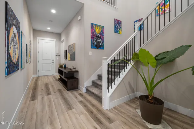 a view of entryway and hall with wooden floor