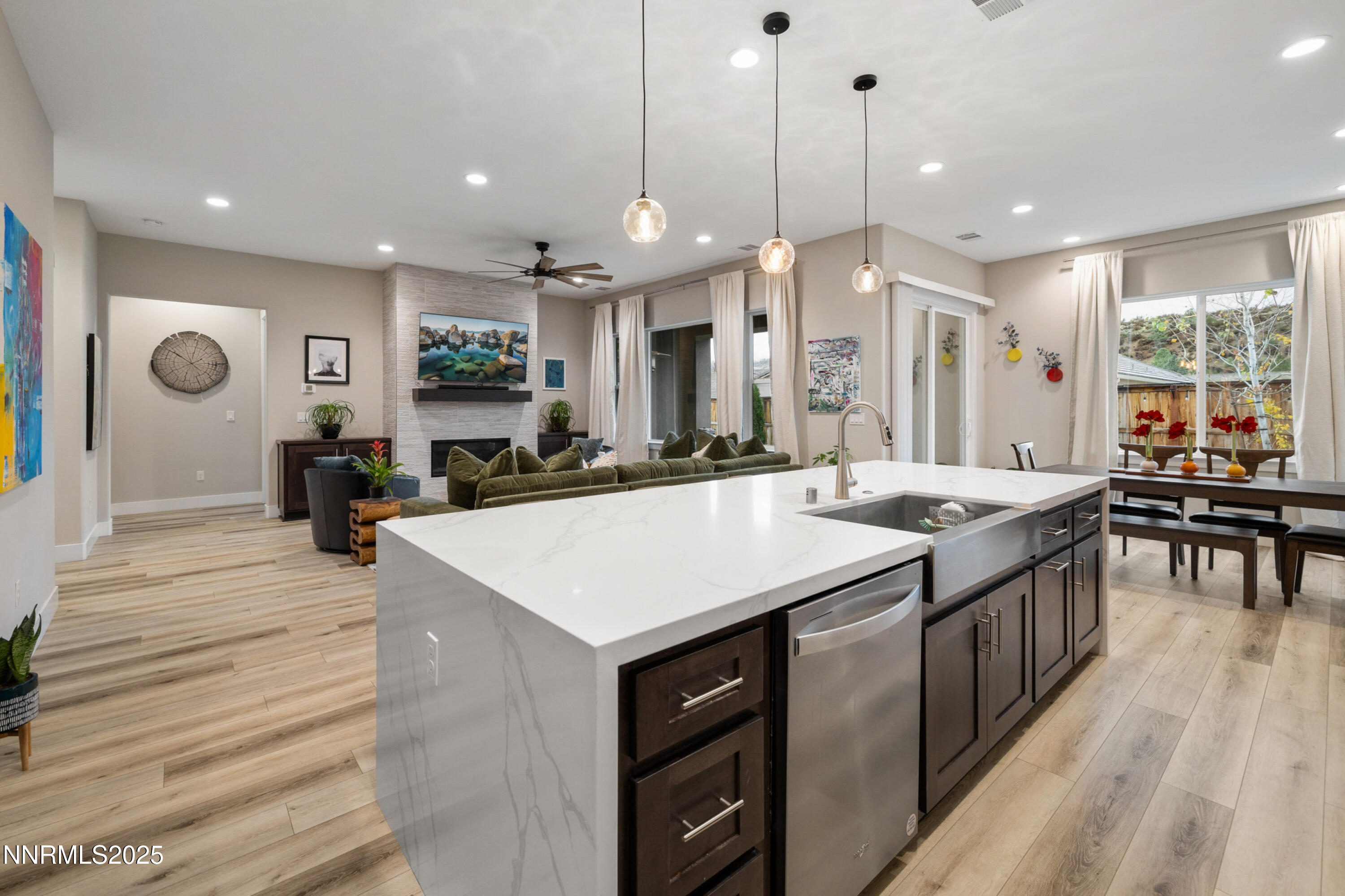 250 Commodore Drive Verdi, NV 89439 - Photo 7 of 43 a kitchen with kitchen island granite countertop a stove a sink a dining table and chairs with wooden floor