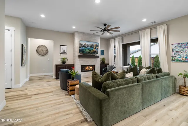 a living room with furniture a fireplace and a flat screen tv