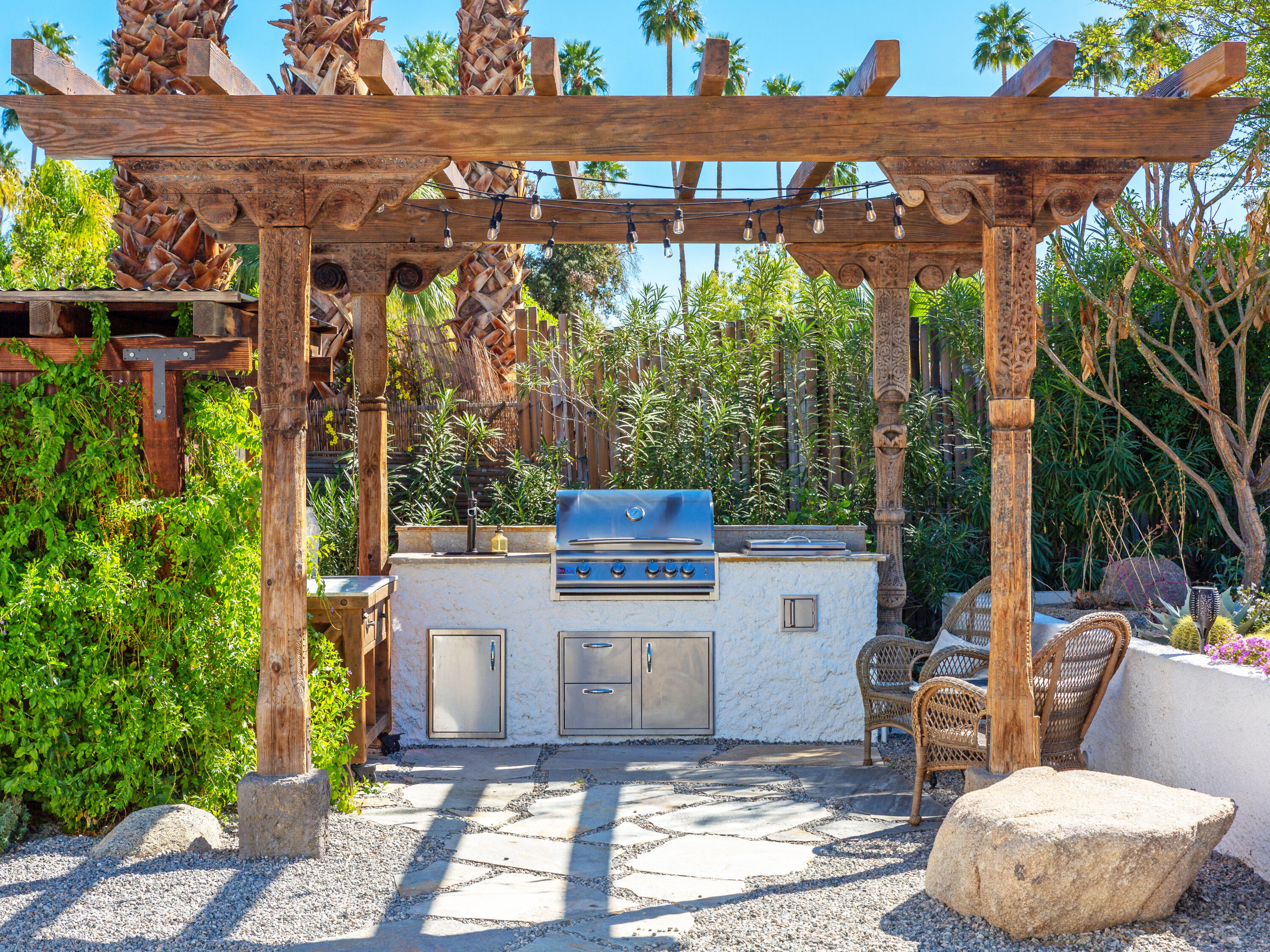 71607 Sahara Road Rancho Mirage, CA 92270 - Photo 11 of 63 a view of a patio with table and chairs potted plants and floor to ceiling window