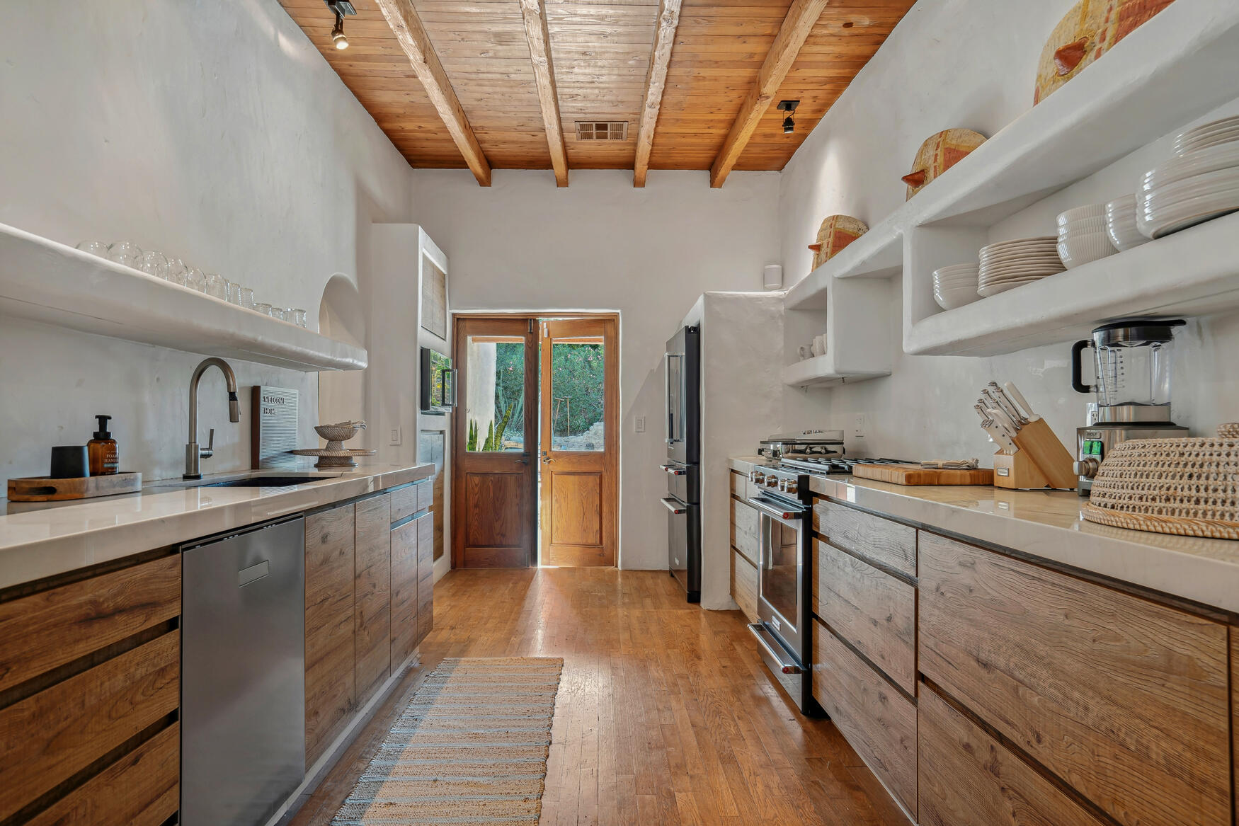 71607 Sahara Road Rancho Mirage, CA 92270 - Photo 4 of 63 a kitchen with stainless steel appliances granite countertop a sink a stove and cabinets
