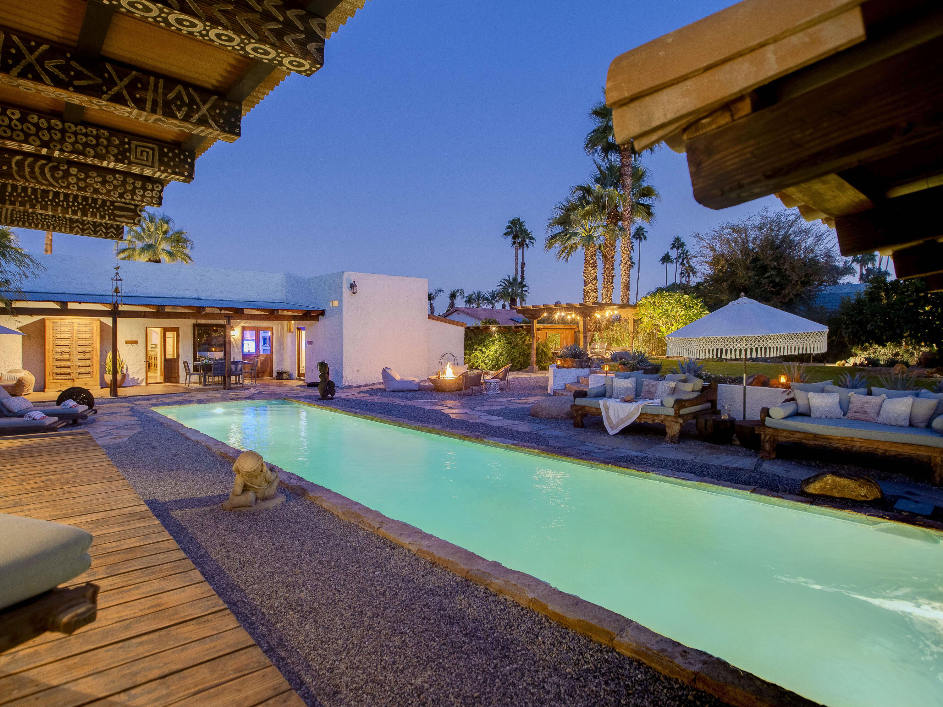 71607 Sahara Road Rancho Mirage, CA 92270 - Photo 7 of 63 a view of a patio with table and chairs under an umbrella