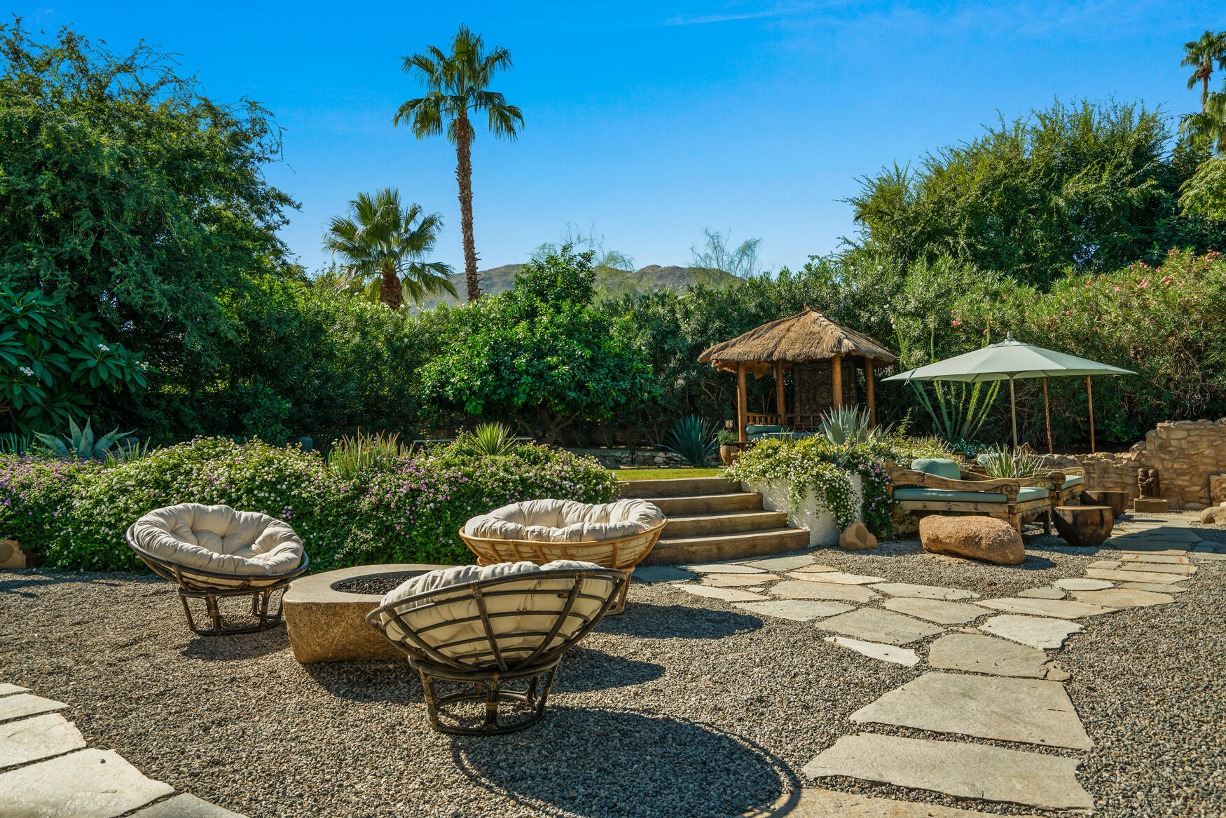 71607 Sahara Road Rancho Mirage, CA 92270 - Photo 9 of 63 a view of a patio with table and chairs potted plants and a palm tree
