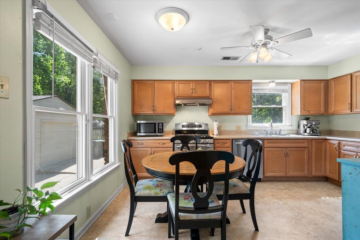 4847 Kaye Road Memphis, TN 38117 - Photo 13 of 40 a kitchen with granite countertop wooden cabinets and stainless steel appliances