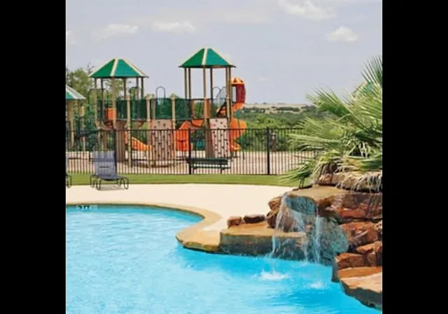 a view of a swimming pool with a patio