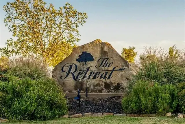 a view of a sign board with yard