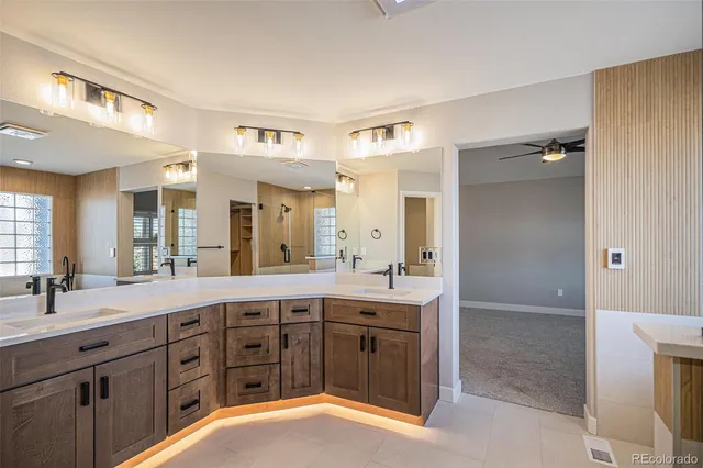 a spacious bathroom with a granite countertop sink mirror and double