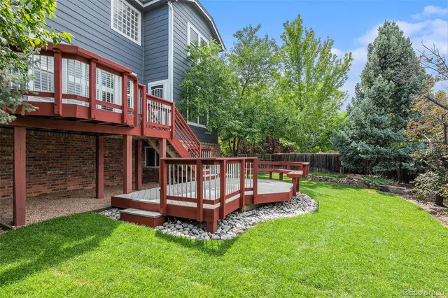 front view of a house with a yard balcony and a slide