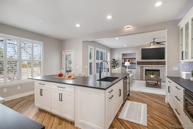 a kitchen with granite countertop a sink and a stove top oven