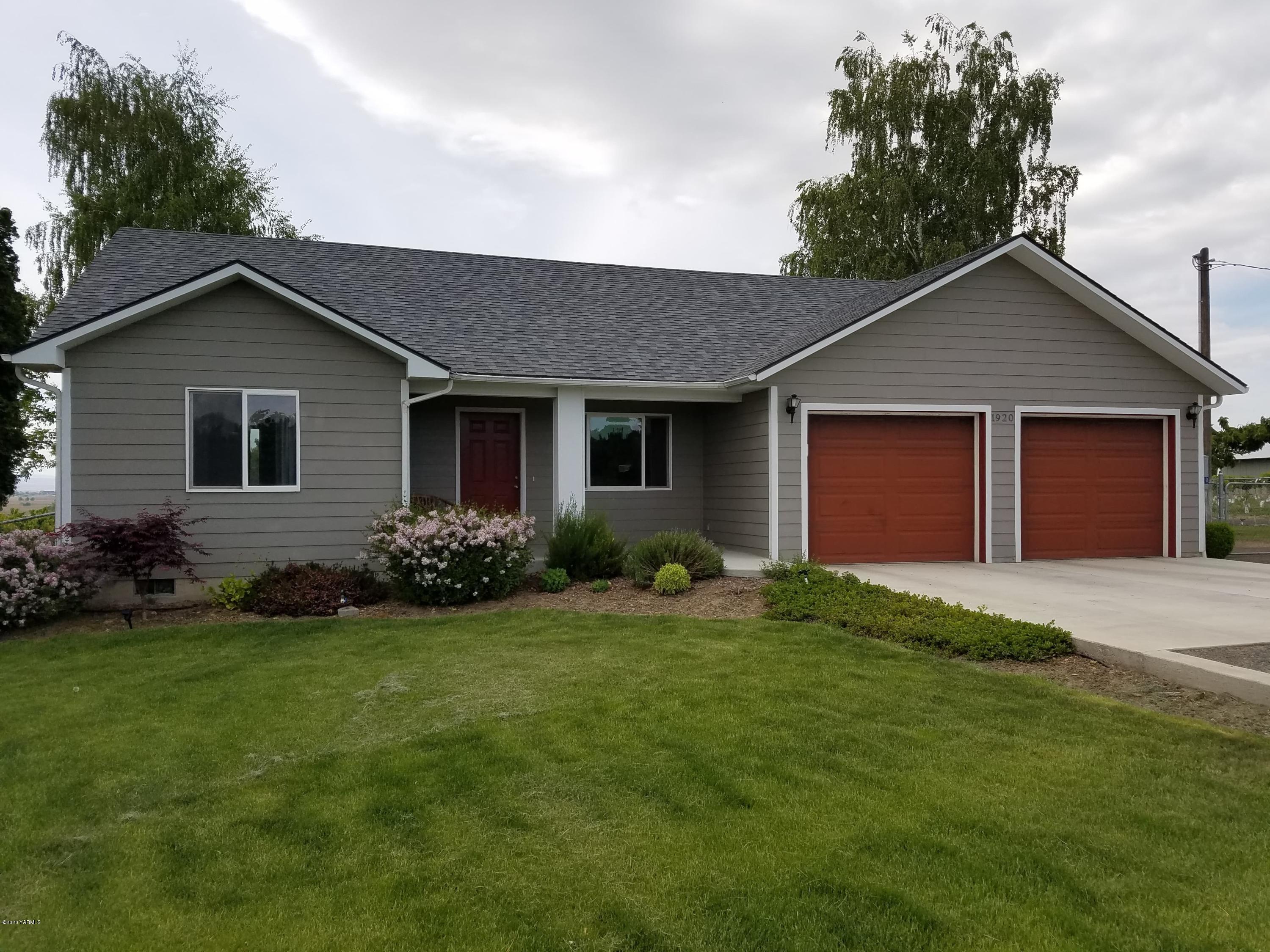 1920 South Euclid Road Grandview, WA 98930 - Photo 1 of 20 a front view of house with yard and green space