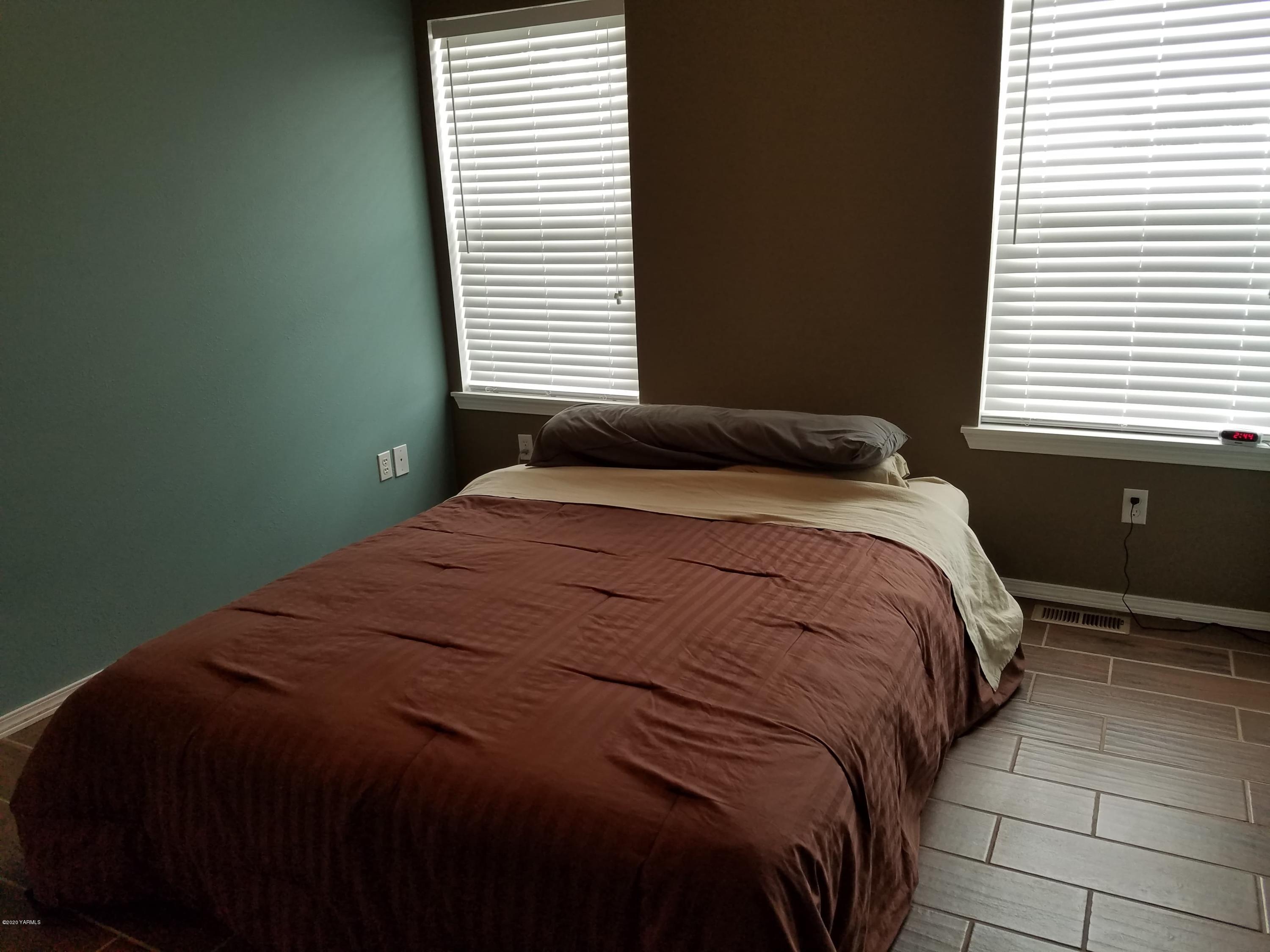 1920 South Euclid Road Grandview, WA 98930 - Photo 14 of 20 a bedroom with a bed and window