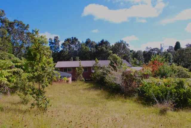 an aerial view of a house with a yard basket ball court and outdoor seating