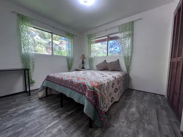 a bedroom with a bed lamp and a window