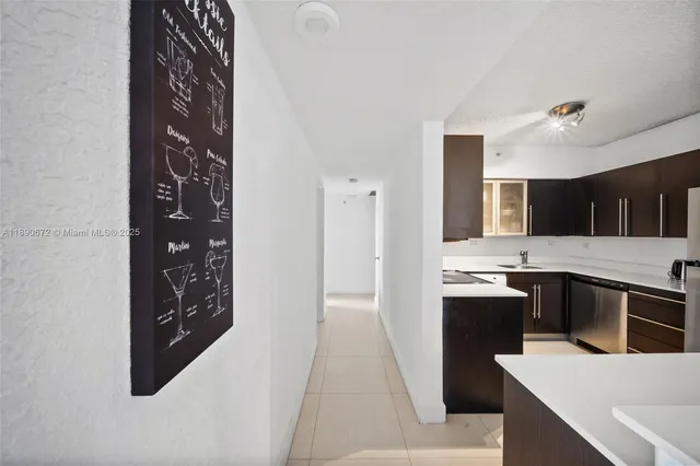 a kitchen with a sink cabinets and stainless steel appliances