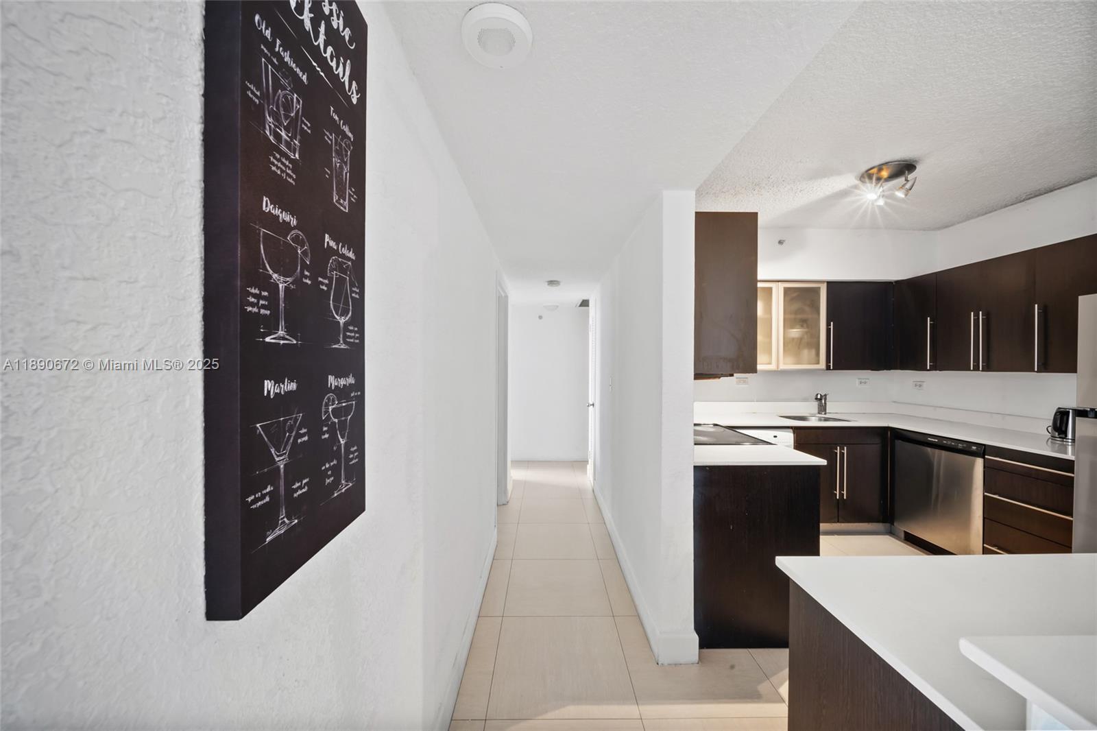 1500 Bay Road, Unit 1228S Miami Beach, FL 33139 - Photo 14 of 35 a kitchen with stainless steel appliances kitchen island granite countertop a sink and cabinets