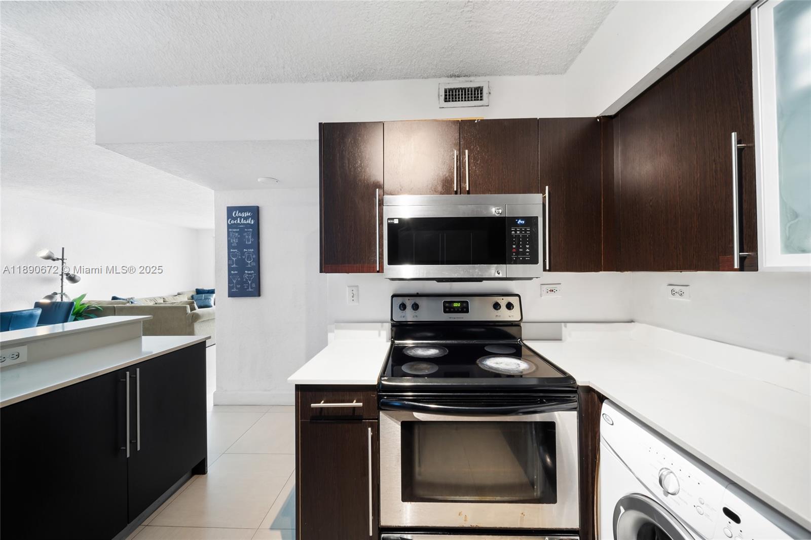 1500 Bay Road, Unit 1228S Miami Beach, FL 33139 - Photo 17 of 35 a kitchen with a stove and a microwave