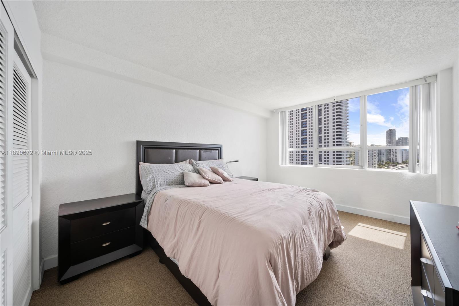 1500 Bay Road, Unit 1228S Miami Beach, FL 33139 - Photo 18 of 35 a bedroom with a bed and a window