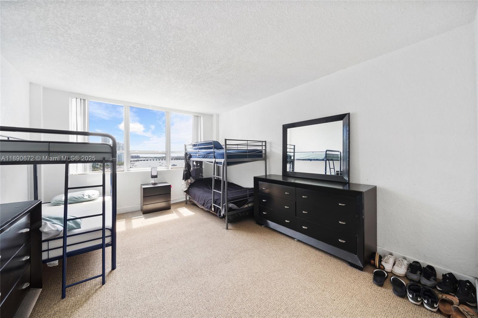 1500 Bay Road, Unit 1228S Miami Beach, FL 33139 - Photo 20 of 35 a bedroom with furniture and a dresser