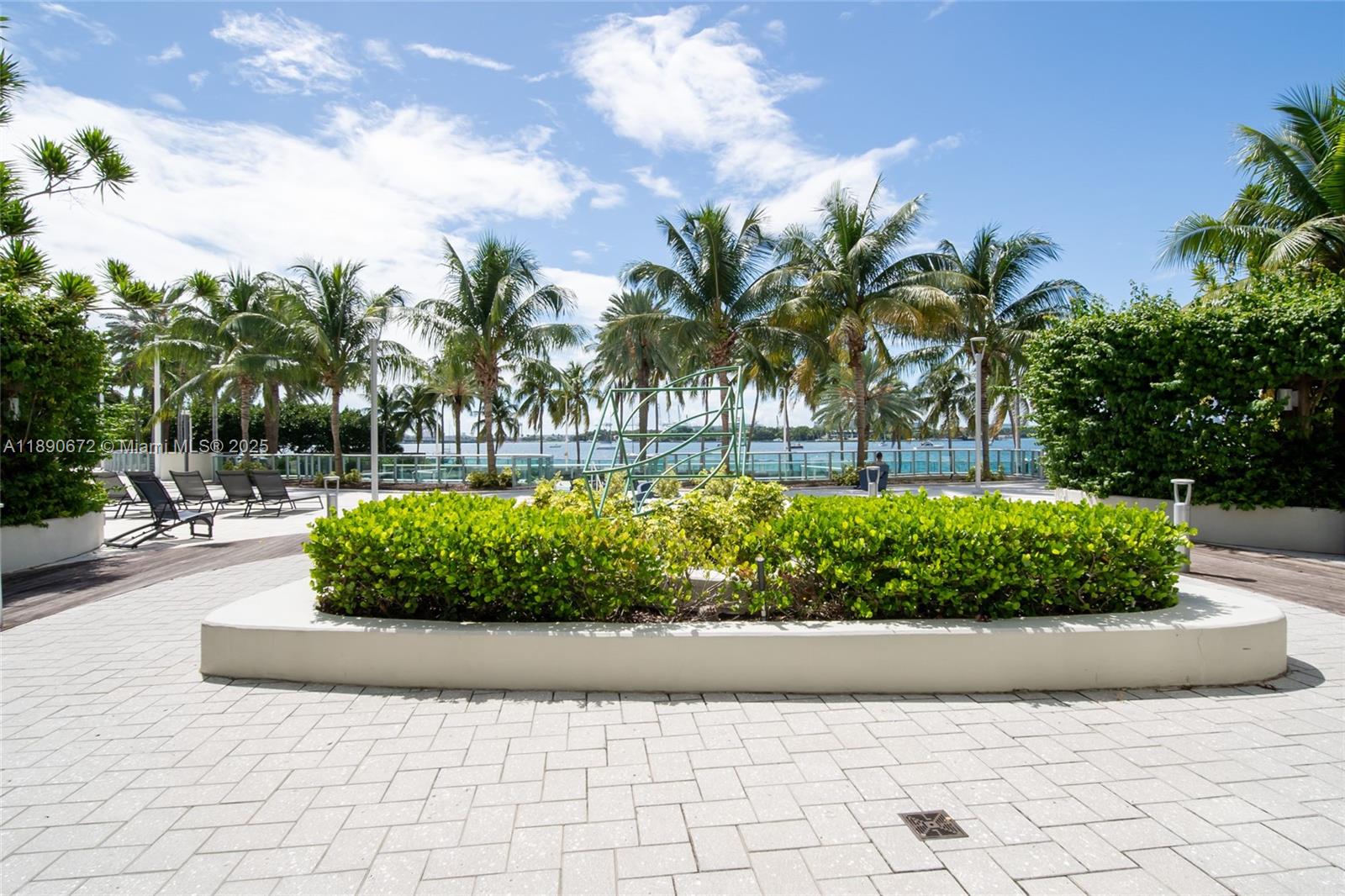 1500 Bay Road, Unit 1228S Miami Beach, FL 33139 - Photo 24 of 35 a view of a garden with a bench