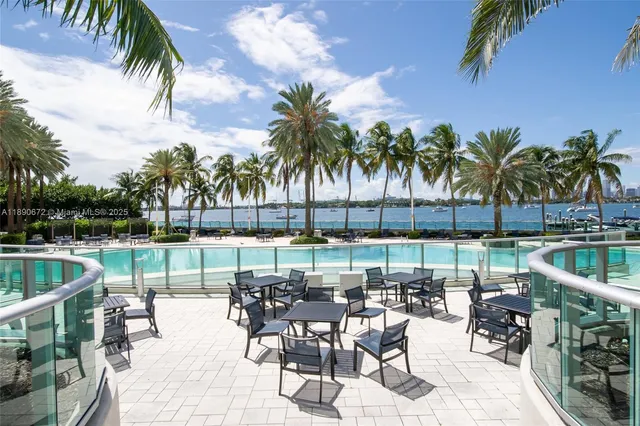 a swimming pool with outdoor seating and yard