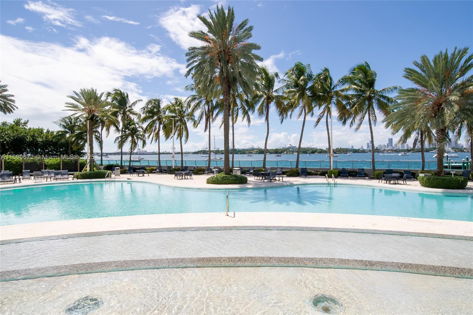 1500 Bay Road, Unit 1228S Miami Beach, FL 33139 - Photo 28 of 35 a view of swimming pool with outdoor seating and lake