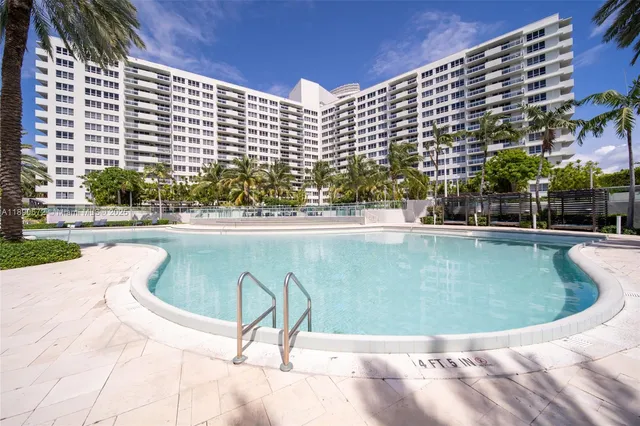 a view of swimming pool with a lounge chairs