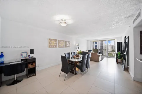 a work room with furniture wooden floor and a flat screen tv