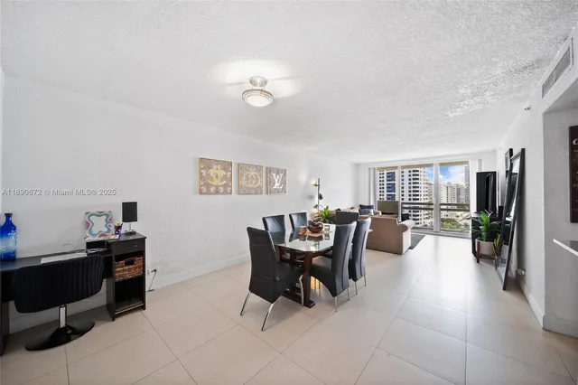 a work room with furniture wooden floor and a flat screen tv