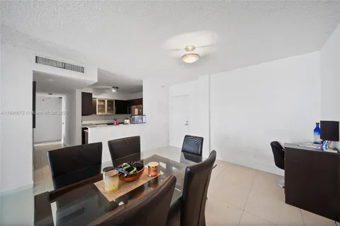 a view of a dining room with furniture and a kitchen