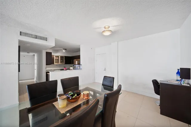 a view of a dining room with furniture and a kitchen