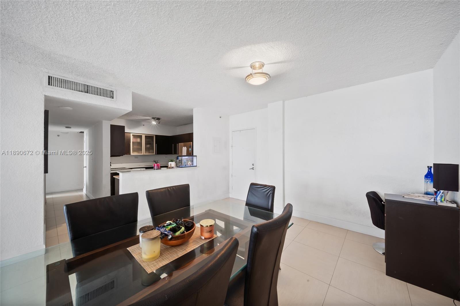 1500 Bay Road, Unit 1228S Miami Beach, FL 33139 - Photo 8 of 35 a work room with furniture wooden floor and a flat screen tv